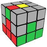 Rubik's cube with centre pieces and first layer coloured, and the red/green edge piece is shown on the top face with green next to the red centre.