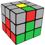 Rubik's cube with centre pieces and first layer coloured, and the red/green edge piece is shown on the top face with red next to the green centre.
